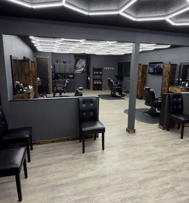 Interior of AVR Luxury Barbershop with leather chairs and warm lighting